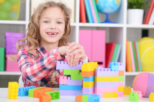 Girl Playing With Plastic Blocks