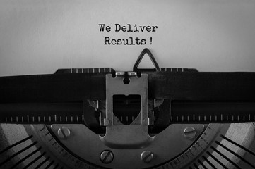 Text We Deliver Results typed on retro typewriter