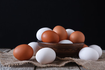 Fresh chicken white and brown eggs on sack closeup, organic farming background