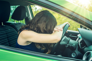 Woman behind the wheel of a car. Hands on the wheel. Focused and tense. Lesson in driving school.