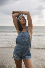 Model girl posing sexy at tropical beach location. Vogue style