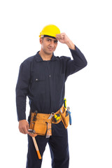 Happy beard worker smiling, guy wearing dark blue workwear and belt equipment with yellow helmet, isolated on white background
