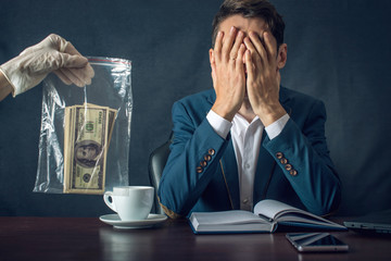 Man Businessman in suit arrested for taking bribe. Caught red-handed. Concept of corruption and...