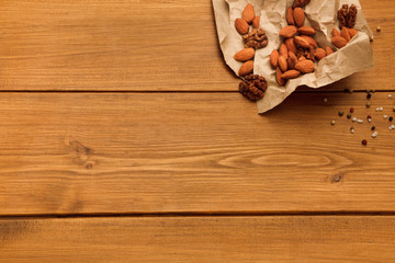 Border of nuts on wooden background with copy space