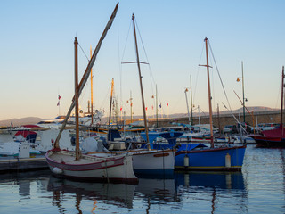 Fototapeta premium Saint-tropez, France - august 9 2017: Three small sailboats in the port of Saint Tropez.