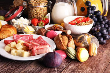 Breakfast served with coffee, orange juice, croissants, cereals and fruits. Balanced diet.