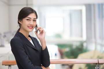 Asian Woman using Smartphone in City with Attractive Smile, Woman working by Smartphone, Woman working Concept.