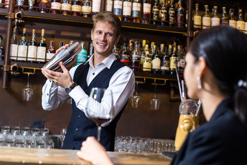 Bartender working and takecare Customer at counter, Bartender enjoy to serving Wine for Customer,...