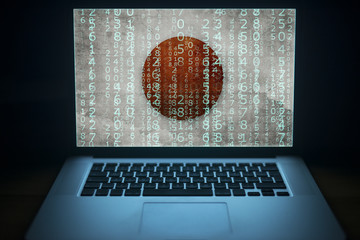 Japan hacker. Laptop with binary computer code and Japanese flag on the screen. Internet and...