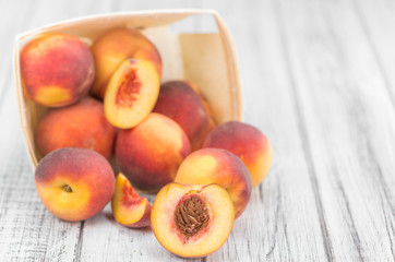 Portion of Fresh Peaches on wooden background, selective focus
