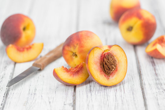 Portion of Fresh Peaches on wooden background, selective focus