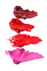 Different multi colored samples of a smudged lipstick