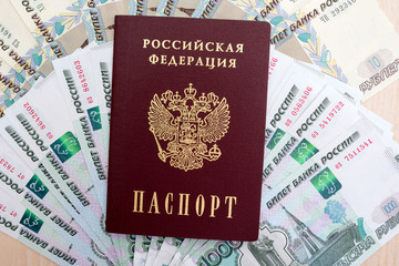 Fototapeta premium Russian passport on the background of ruble banknotes 
