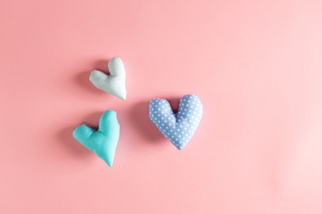 Handmade heart cushions on a red background