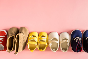 Baby shoes on a pale pink background