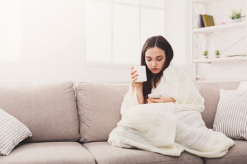 Cozy home. Girl in a plaid with mobile