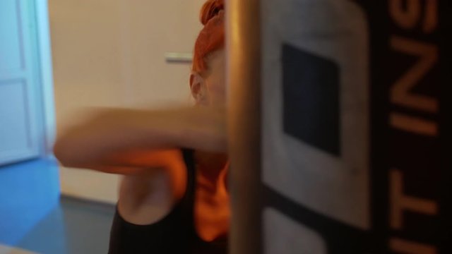 Beautiful red hair woman boxing in hard training in GYM