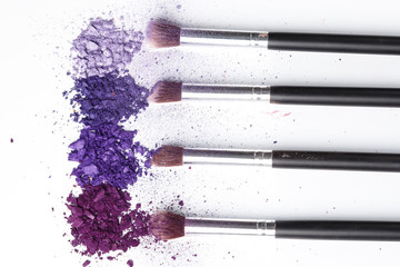 Fototapeta premium Crushed eyeshadows and make-up brushes