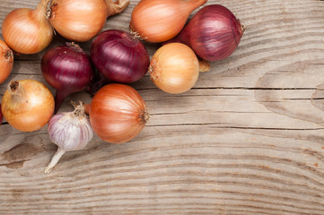 vegetables crop  on wooden background onions garlic, top view, copy space