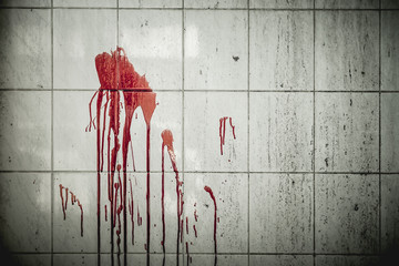 A drop of blood on a wall in an abandoned house them. Background operators in Halloween...
