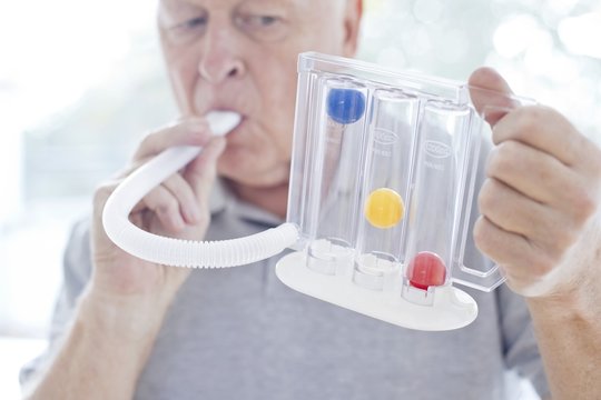 Senior using incentive spirometer