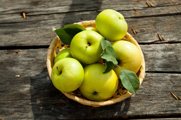 Green apples on a rustic wooden background