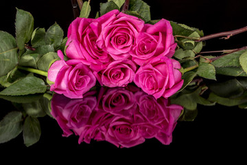 Bouquet of pink roses on a black surface