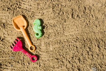 children's toys in the sandbox. Top view
