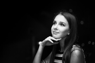 Girl looking on a moon at night, city view, black and white photo