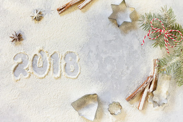 Ingredients for Christmas baking - spices, powdered sugar and cookie shapes on a stone background. Seasonal, food background.