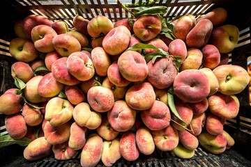 Fresh saturn peaches in a basket