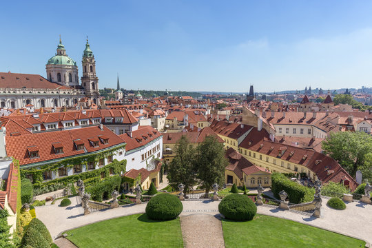 View of the Vrtba Garden (Vrtbovsk&aacute; zahrada), St. Nicholas Church and other old buildings at the Mala Strana District (Lesser Town) in Prague, Czech Republic on a sunny day.