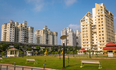 View of planned city with modern residential buildings with park and over bridge at Kolkata India