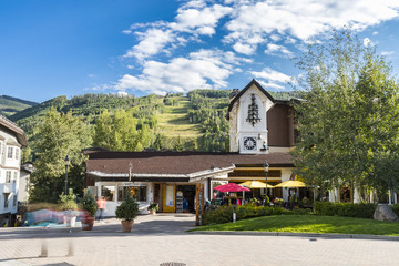 tourists shopping at a ski village on a beautiful summer day