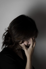 Beautiful young woman wearing black dress and red lips in the dark concept, Concept : dark, halloween, mysterious, depressed