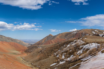 picturesque view of road between of snow-covered mountain terrain 
