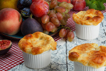 Cheese souffle and fruits on the rustic table.