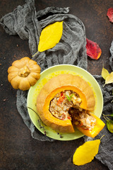 Baked pumpkin stuffed with Turkey, tomatoes, onions and cheese. The concept of food on thanksgiving. Top view with copy space.