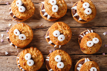 Halloween Dessert: funny monsters from cookies close-up. horizontal view from above