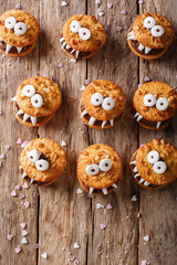 Halloween Dessert: funny monsters from cookies close-up. Vertical view from above