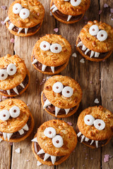 Peanut biscuit monsters for Halloween close-up on the table. vertical view from above