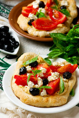 Hummus pita pizzas.