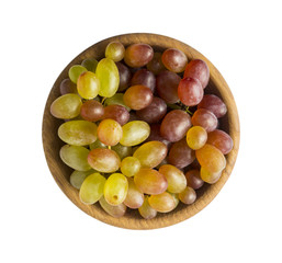Grapes in a wooden bowl isolated on white background. Green grapes Kish Mish. Top view