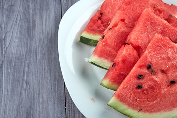 Chopped pieces of watermelon on a white plate