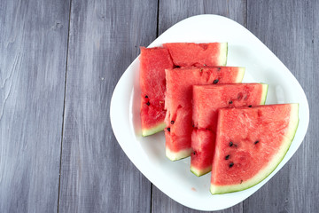 Chopped pieces of watermelon on a white plate