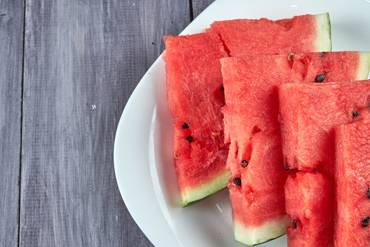 Chopped pieces of watermelon on a white plate
