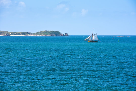 Fototapeta Bright blue sea and a yacht