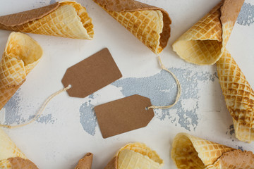 Empty waffle cones on white stone table. Space for text