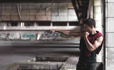 Serious young man in an old stadium