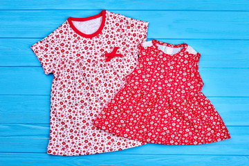 Trendy cotton dresses for kids. New small flower design natural childs apparel, blue wooden...